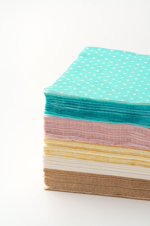 Colorful stack of paper napkins on white background