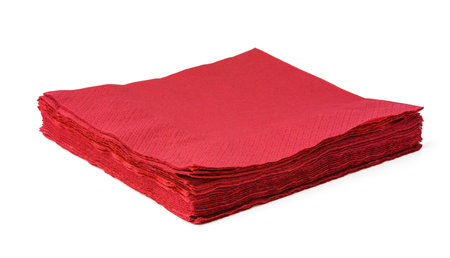 Stack of red paper napkins isolated on white backgroundの写真素材