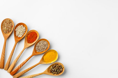 Spice in wooden spoons on white backgroundの写真素材