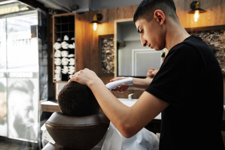 ISTANBUL, TURKEY - MAY 16, 2022: Man client sitting in the barbershop in Esenyurt, Istanbulのeditorial素材
