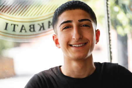 ISTANBUL, TURKEY - MAy 16, 2022: Portrait of a young man barbershop employee in Esenyurt, Istanbul