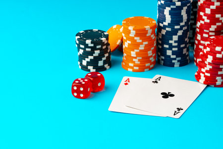 Playing cards and poker chips on blue background