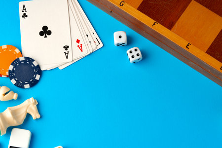 Playing cards, chips and dice on blue backgorund