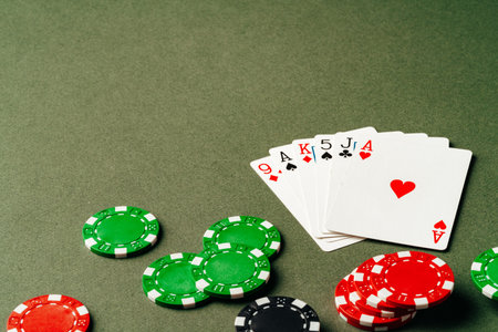 Playing cards and chips on green background