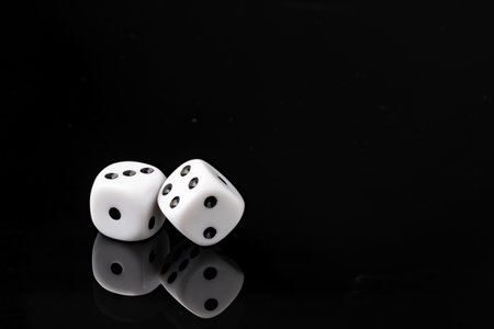 White dice on black background studio shotの写真素材