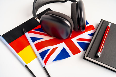 German and British flags with notepad on white backgroundの写真素材