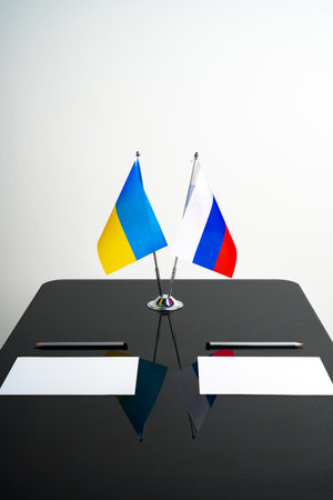 Russia and Ukraine flags on negotiation tableの写真素材