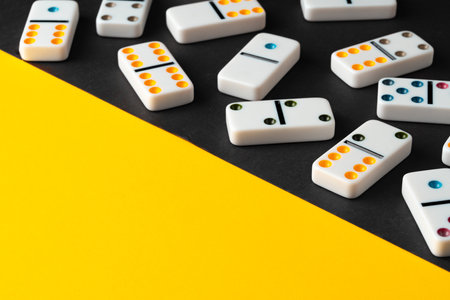 Domino tiles on black and yellow backgroundの写真素材