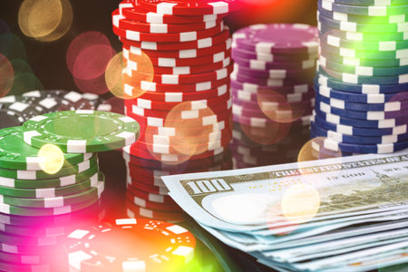 Poker chips and dollar bills on black background studio shotの写真素材