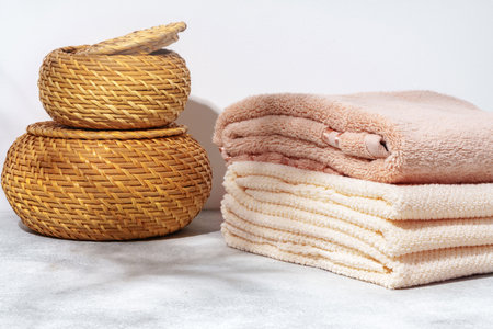 Stacked clean fluffy towels in a bathroomの写真素材