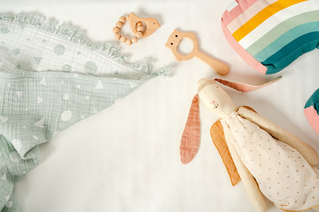 Toys and muslin soft blanket in baby bed close upの写真素材