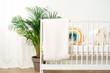 White wooden baby crib in nursery roomの写真素材