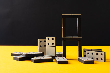 Domino tiles on yellow background studio shotの写真素材