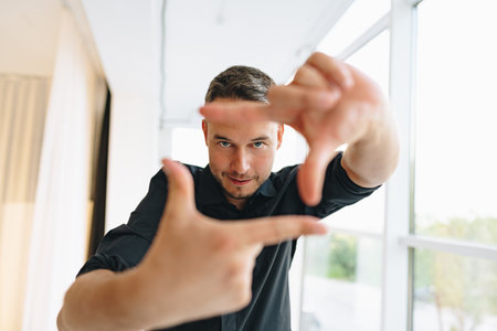 Portrait of a man in black shirt posing in photostudioの写真素材
