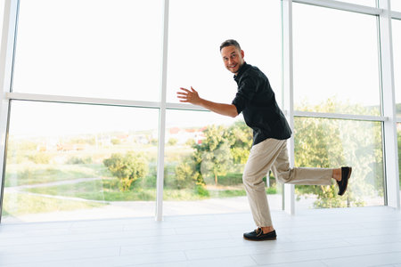 Portrait of a man in black shirt posing in photostudioの写真素材