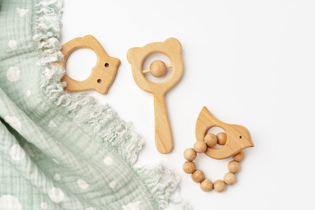 Muslin swaddle blanket with wooden toys on white backgroundの写真素材