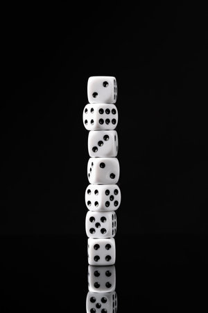 White dice on black background studio shot