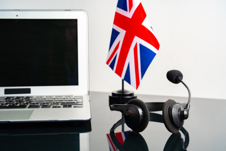 Online education concept with UK flag next to a laptopの写真素材