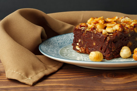 Brownie cake with chocolate and hazelnuts on plateの写真素材