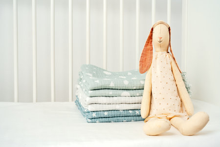 Stack of cotton blankets for a newborn in a cradleの写真素材