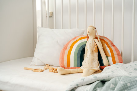 Wooden white baby crib and toy rabbit close upの写真素材