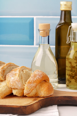 Fresh bread on wooden cutting board in the kitchenの写真素材