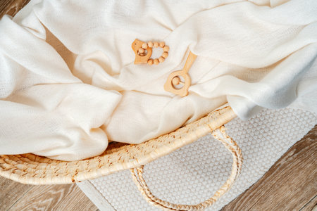Muslin blanket and wooden toys in baby cradleの写真素材