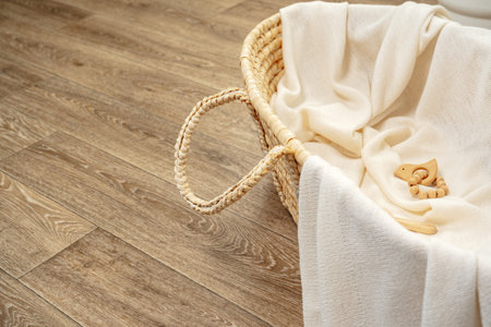 Muslin blanket and wooden toys in baby cradleの写真素材