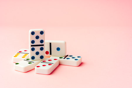 Domino tiles on pink background studio shotの写真素材