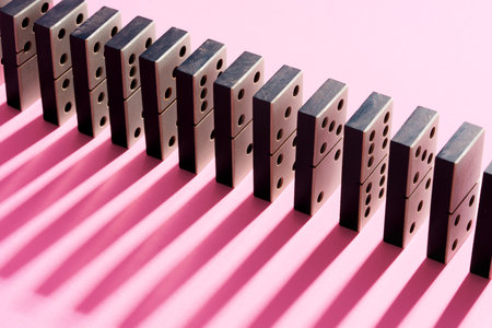 Row of domino tiles on pink studio backgroundの写真素材
