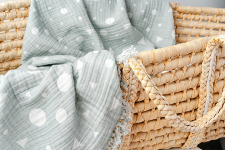 Baby cradle with muslin blanket and wooden toys in a baby roomの写真素材