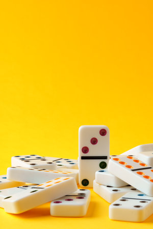 Domino tiles on yellow background studio shotの写真素材