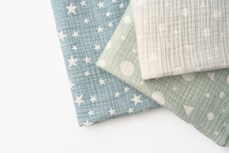 Three folded cotton blankets on white background