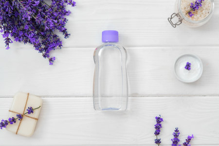 Lavender soap bars and spa products with lavender flowers on a white wooden tableの写真素材