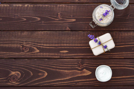 Lavender cosmetics and lavender flowers on dark wooden backgroundの写真素材