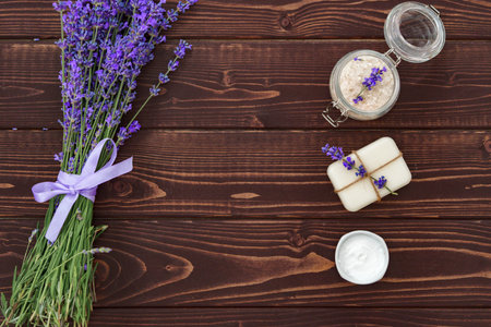 Lavender cosmetics and lavender flowers on dark wooden backgroundの写真素材