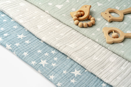 Baby muslin blanket and wooden toys for newbornの写真素材