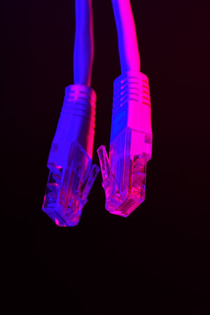 Modern technology network cable in neon light.