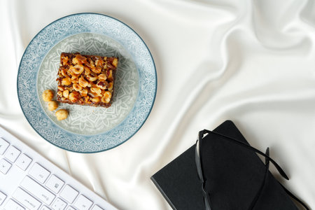 Piece of brownie cake with hazelnuts on white backgroundの写真素材