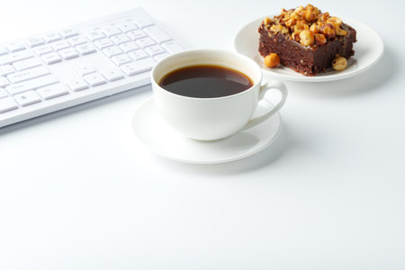 Piece of brownie cake with hazelnuts on white backgroundの写真素材