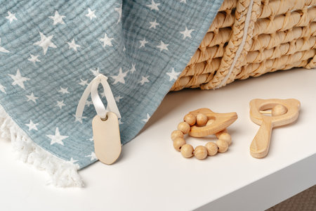 Baby cradle with muslin blanket and wooden toys in a baby roomの写真素材