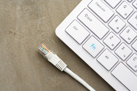 Computer keyboard with network cable close upの写真素材