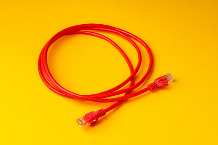 Network cable on yellow background studio shotの写真素材