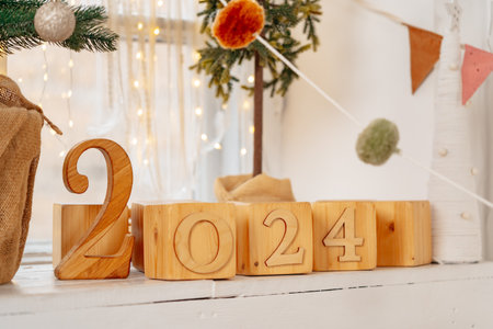 Wooden cubes year 2024 on decorated windowsillの写真素材