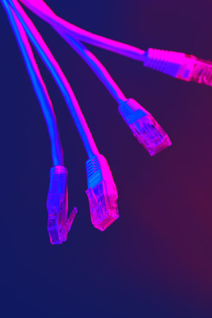 Modern technology network cable in neon light.の写真素材