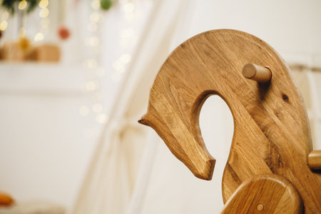 Kids tipi tent and wooden rocking horse in a roomの写真素材