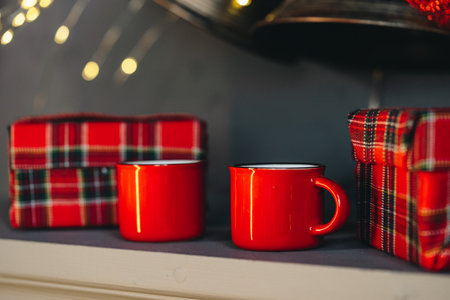 Christmas gift box and two cups of hot coffee set on tableの写真素材