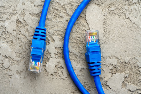 Colored network cable patch-cord on gray textured background