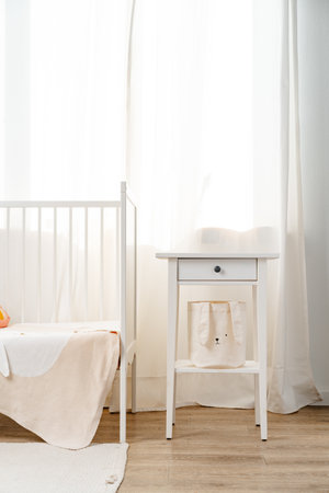 Baby bedroom interior with white wooden nightstandの写真素材