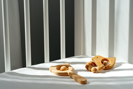 Wooden toys rattle in a baby bedの写真素材